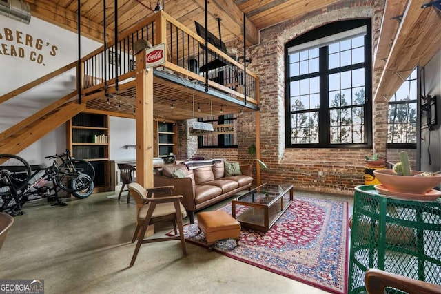 living room with wood ceiling, a towering ceiling, and brick wall