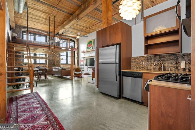 kitchen with brick wall, beamed ceiling, sink, a chandelier, and stainless steel appliances