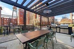 view of patio / terrace with exterior kitchen, a bar, and a pergola