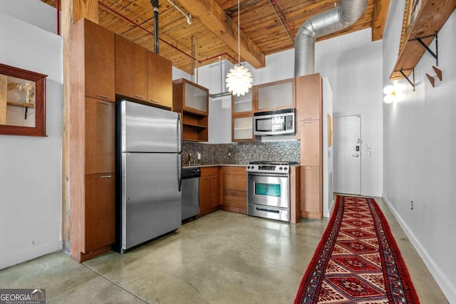 kitchen featuring tasteful backsplash, hanging light fixtures, appliances with stainless steel finishes, beamed ceiling, and a high ceiling