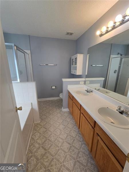 full bathroom with vanity, separate shower and tub, and toilet