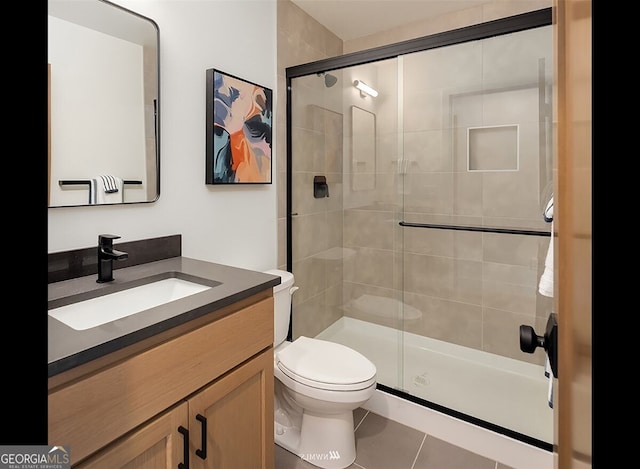 bathroom with walk in shower, tile patterned floors, toilet, and vanity