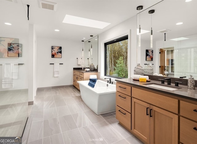 bathroom with vanity, plus walk in shower, tile patterned floors, and a skylight