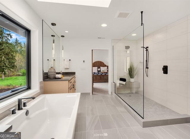 bathroom featuring tile patterned flooring and tiled shower