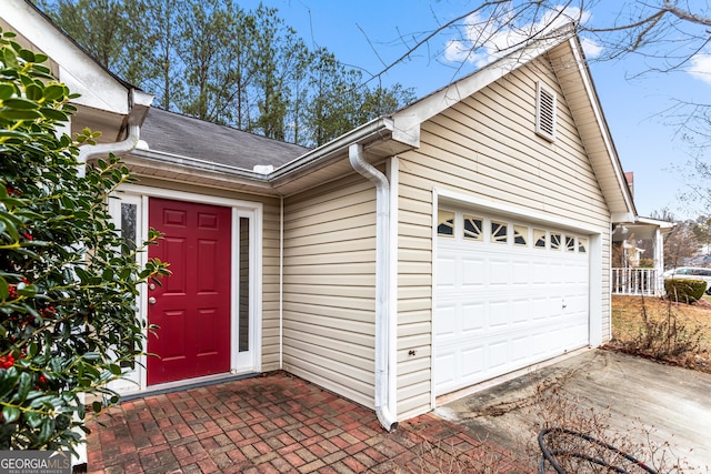 doorway to property with a garage