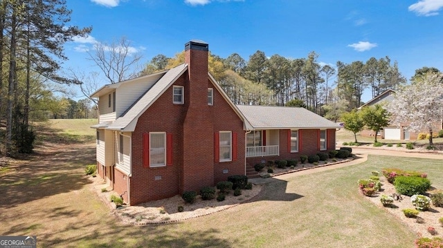 view of side of property with a yard and covered porch