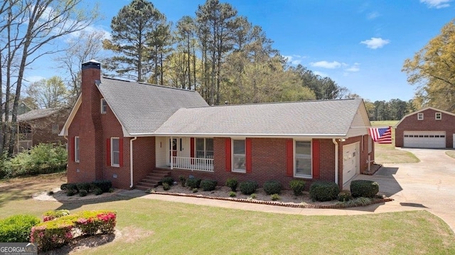 view of front of home featuring an outbuilding, a garage, covered porch, and a front lawn