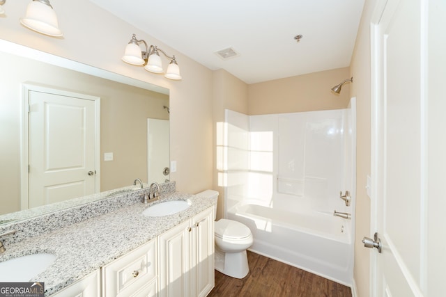 full bathroom featuring wood-type flooring, toilet,  shower combination, and vanity