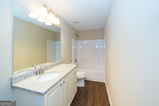 bathroom featuring visible vents, bathing tub / shower combination, toilet, wood finished floors, and vanity