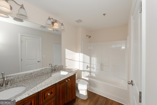 bathroom with visible vents, wood finished floors, a sink, and toilet