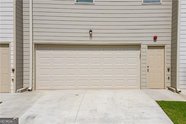 garage with concrete driveway