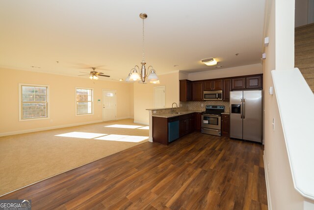 kitchen featuring sink, stainless steel appliances, dark brown cabinetry, dark hardwood / wood-style flooring, and decorative backsplash