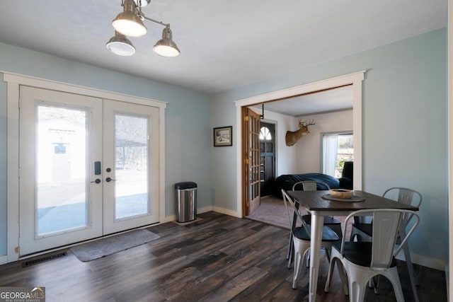 dining space featuring dark wood-type flooring and french doors