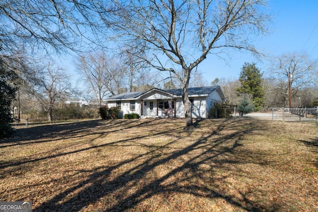 exterior space featuring a front lawn and covered porch