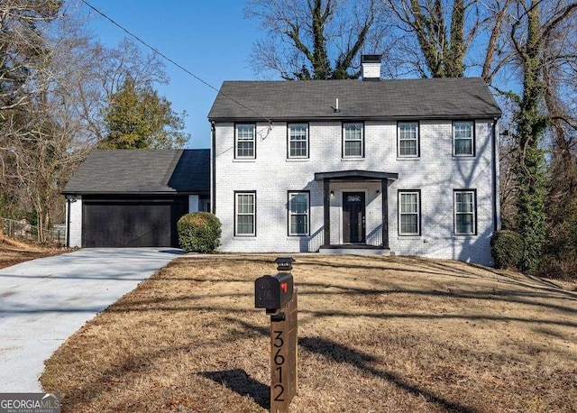 colonial-style house with a garage and a front yard