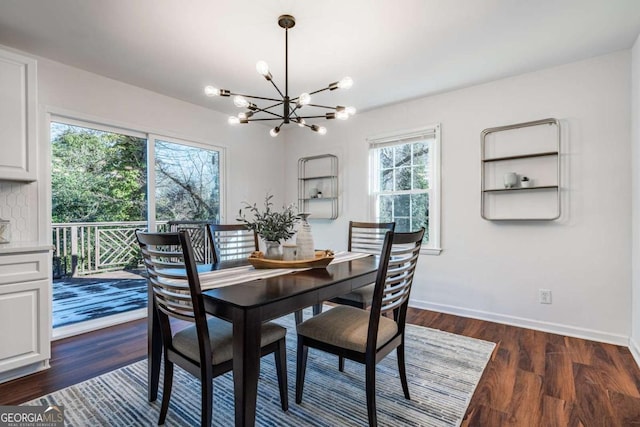 dining space featuring dark hardwood / wood-style flooring and a notable chandelier