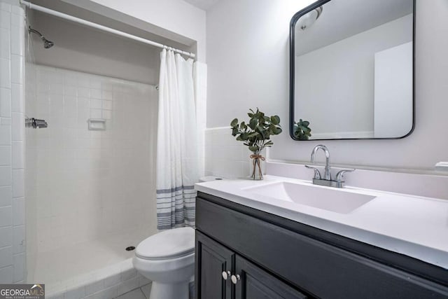 bathroom featuring vanity, a shower with shower curtain, and toilet