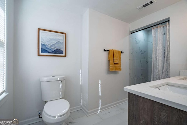 bathroom with vanity, walk in shower, and toilet