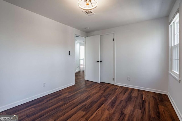 unfurnished room featuring dark hardwood / wood-style flooring