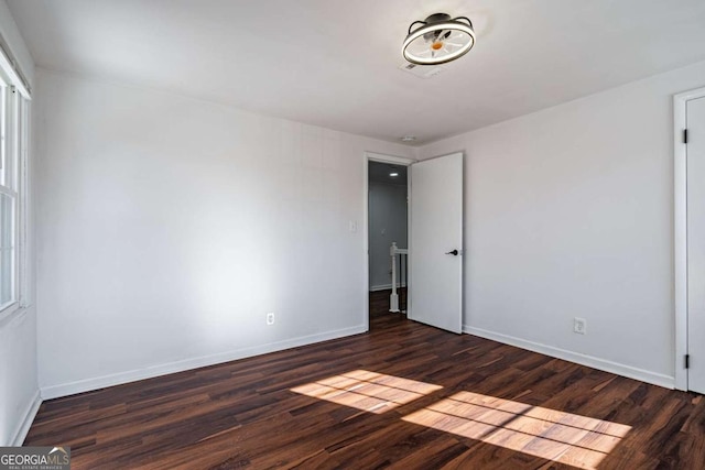 spare room featuring dark hardwood / wood-style flooring