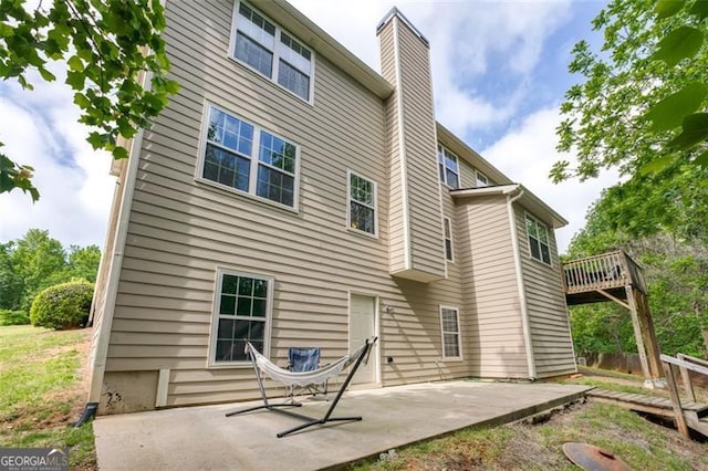 back of property featuring a patio area