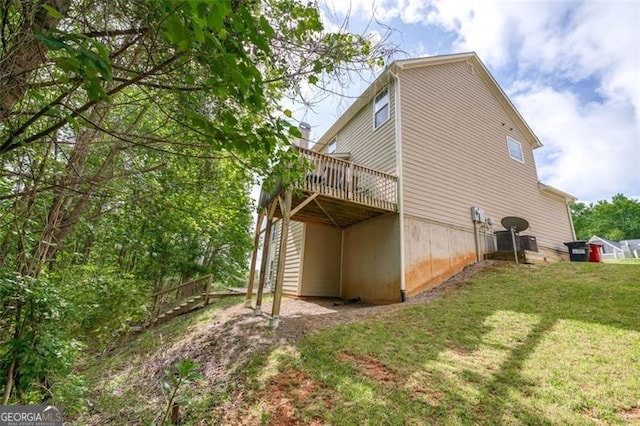 view of side of property featuring a yard and a deck