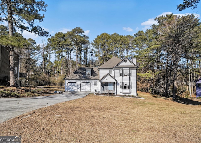 view of front of property with a garage and a front yard