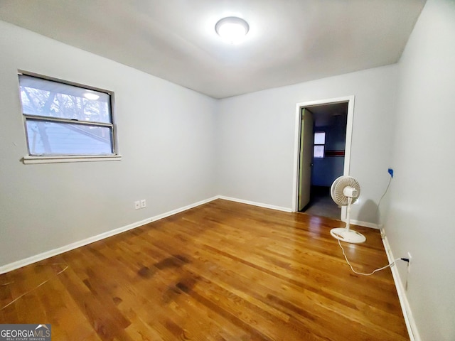 unfurnished room with wood-type flooring