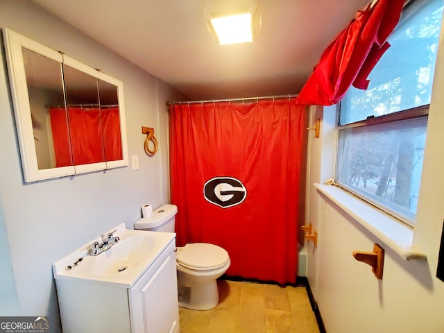 full bathroom with vanity, shower / tub combo, and toilet