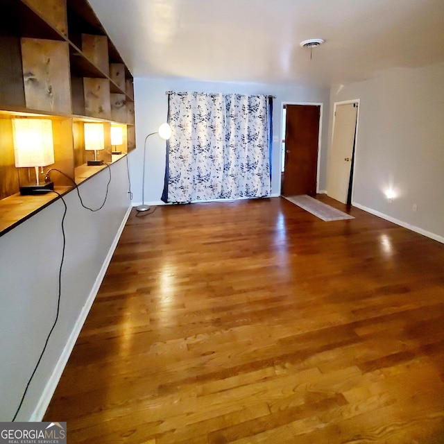 unfurnished living room featuring wood-type flooring