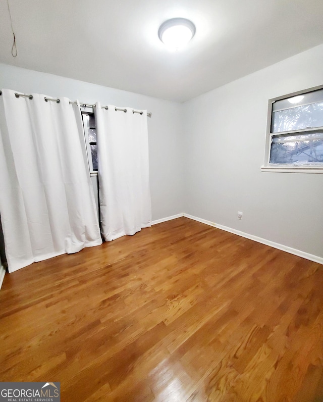 spare room with hardwood / wood-style flooring