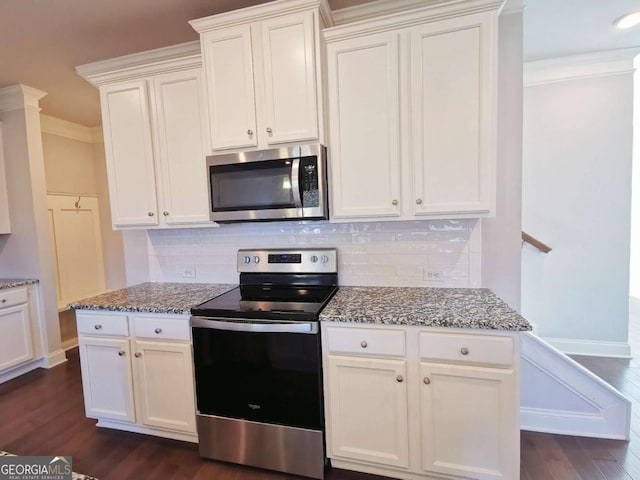 kitchen with stainless steel appliances, white cabinetry, dark hardwood / wood-style floors, and light stone counters