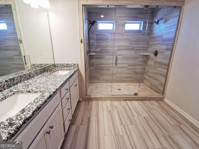 bathroom featuring vanity and a shower with door