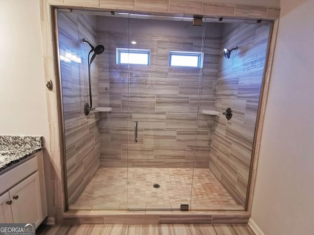 bathroom featuring vanity and an enclosed shower