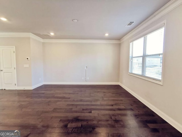 unfurnished room featuring ornamental molding and dark wood-type flooring