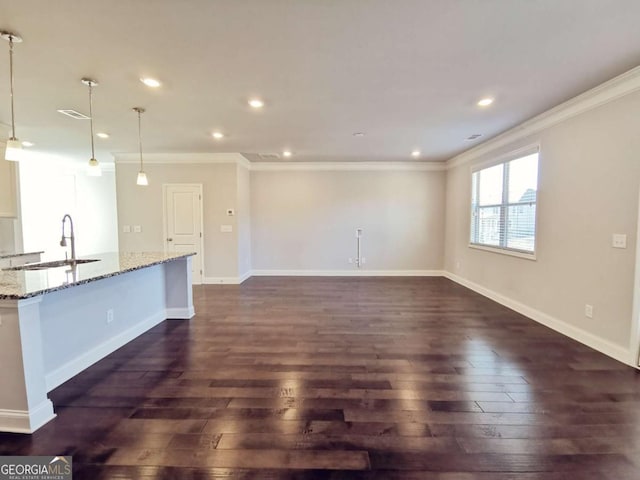 unfurnished living room with ornamental molding, dark hardwood / wood-style flooring, and sink