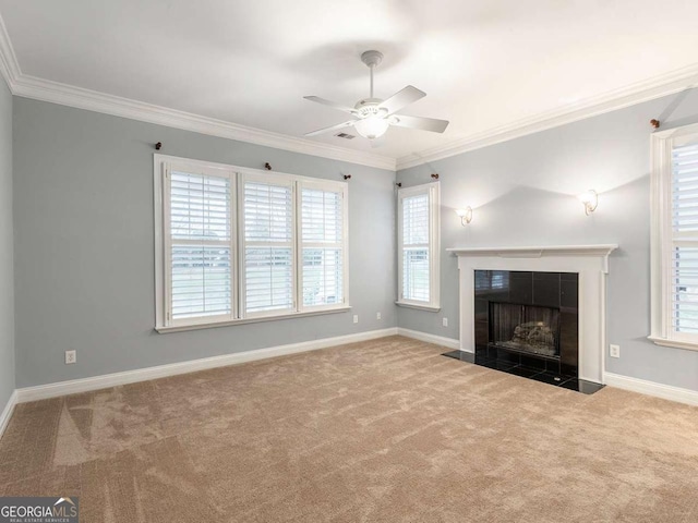 unfurnished living room featuring a tile fireplace, ornamental molding, and carpet