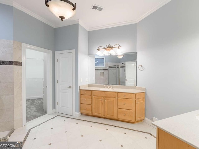 bathroom with ornamental molding, an enclosed shower, and vanity