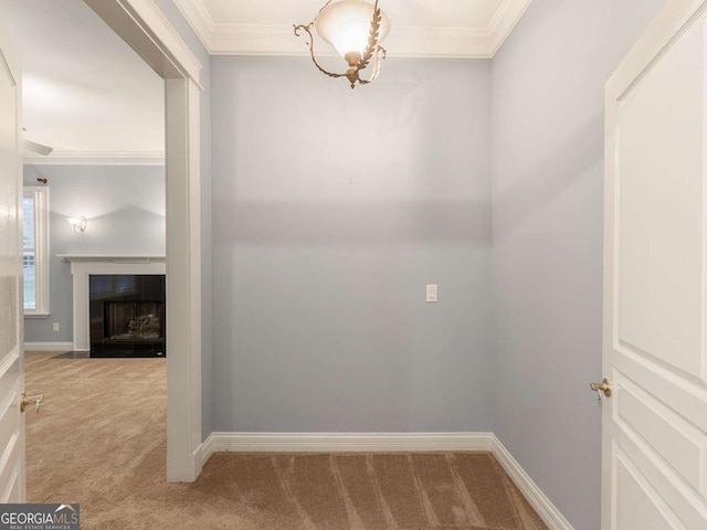 hall with crown molding and light colored carpet