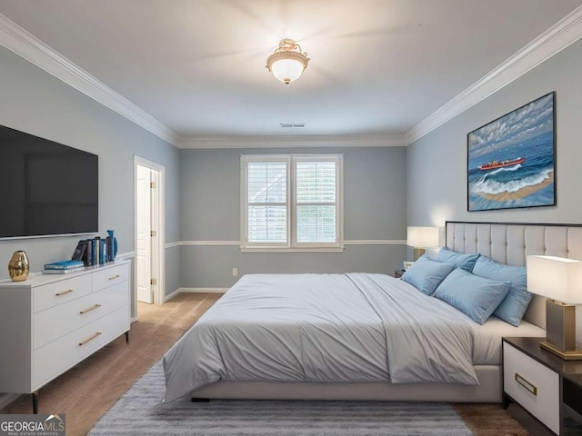 bedroom with crown molding and light hardwood / wood-style floors