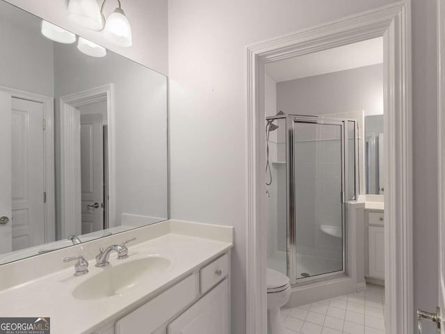 bathroom featuring walk in shower, tile patterned floors, vanity, and toilet