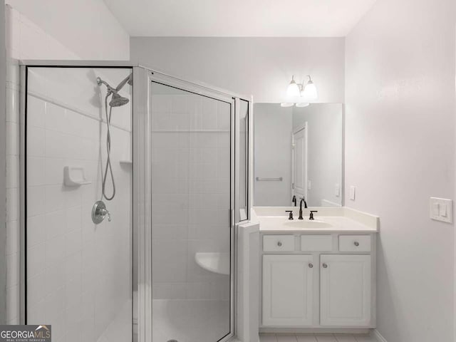 bathroom featuring vanity, tile patterned floors, and a shower with door