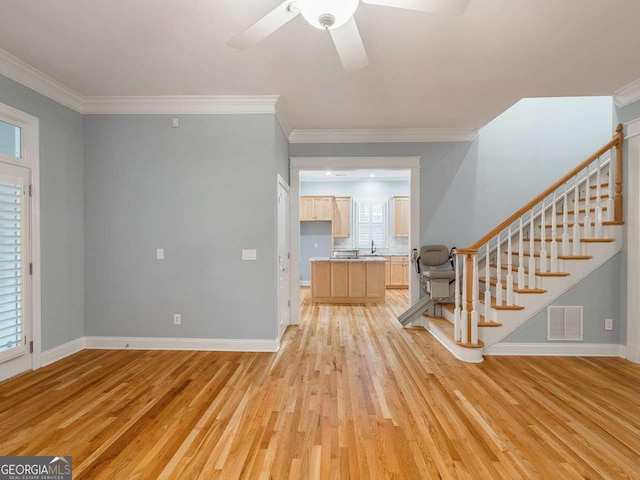 foyer with sink, light hardwood / wood-style flooring, and ornamental molding