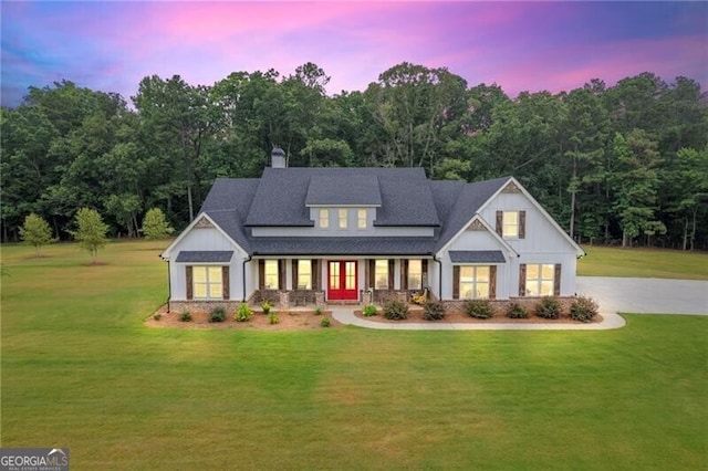 view of front of property with a lawn and a porch