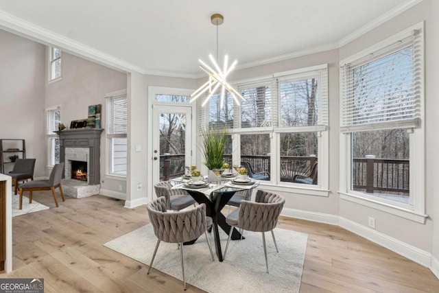 dining area featuring ornamental molding, a chandelier, and light wood-type flooring