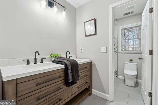 bathroom featuring vanity, toilet, and tile patterned flooring