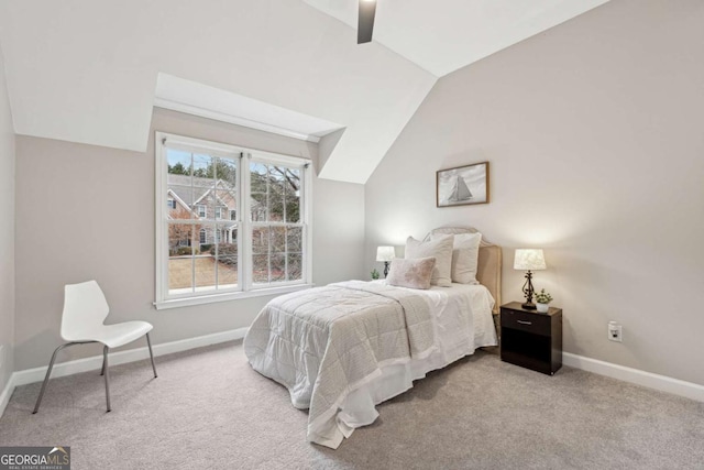 carpeted bedroom featuring lofted ceiling and ceiling fan