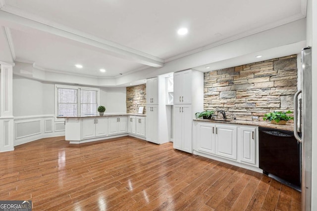 kitchen featuring dishwasher, stainless steel fridge, white cabinets, kitchen peninsula, and crown molding