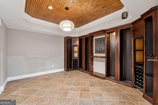 spare room with crown molding, a raised ceiling, and wooden ceiling