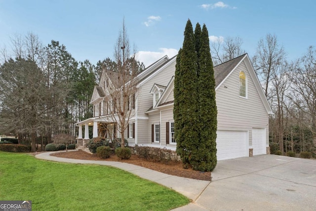 view of side of property with a garage and a lawn